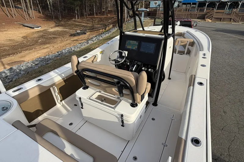 Slide: The Image of 2024 Sea Born SX239 Offshore boat interior with helm and seating area. - 9