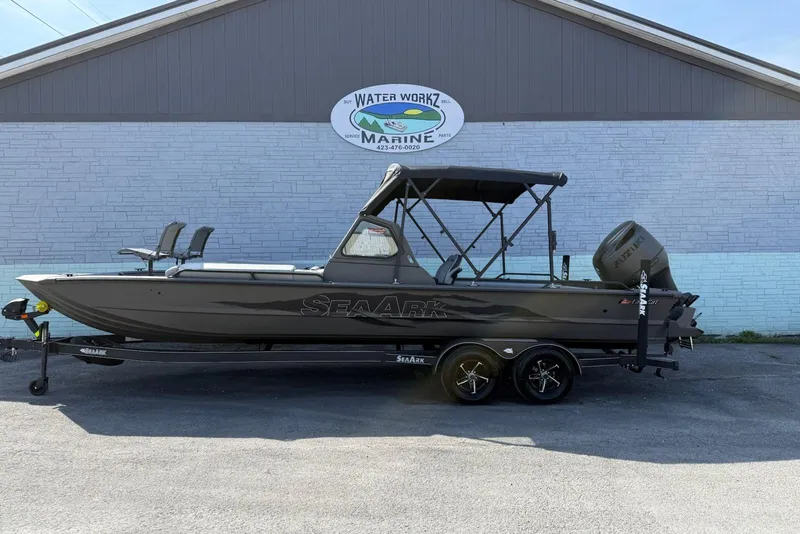 The Image of 2026 SeaArk EasyCat boat on trailer, parked outside Water Workz Marine building. - 1