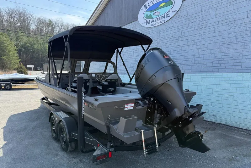 Slide: The Image of 2026 SeaArk EasyCat boat with Suzuki outboard motor on trailer, parked outside marine shop. - 4