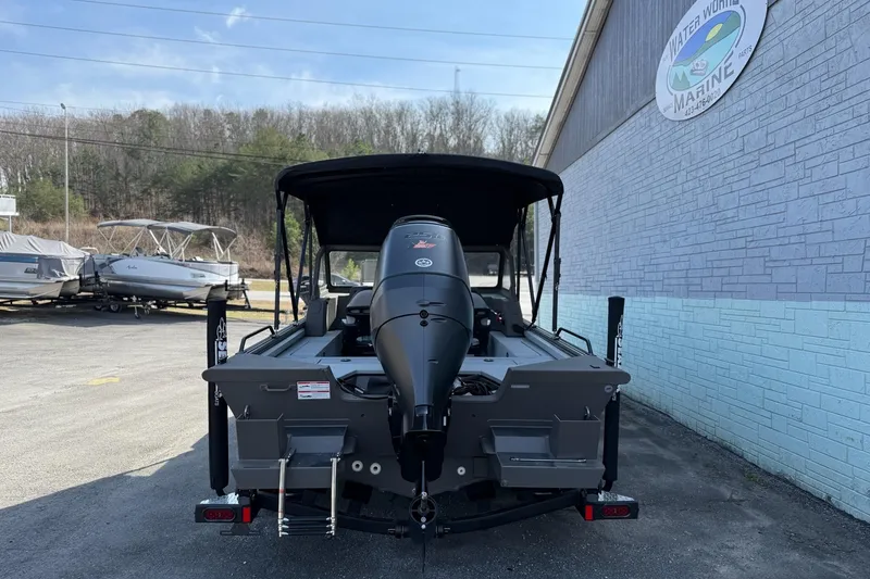 Slide: The Image of 2026 SeaArk EasyCat boat with outboard motor, parked at Water World Marine. - 5