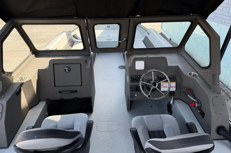 Slide: The Image of 2026 SeaArk EasyCat boat interior with steering wheel, seats, and dashboard controls. - 6