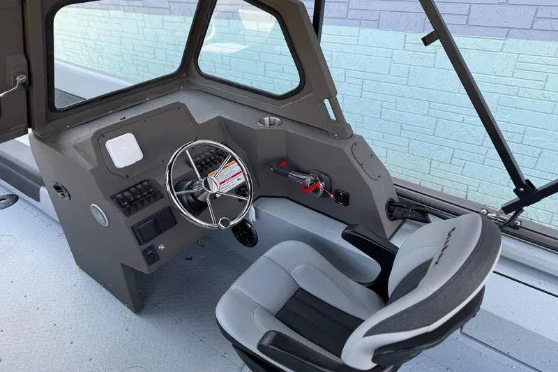 Slide: The Image of Interior of 2026 SeaArk EasyCat boat with steering wheel and control panel. - 7