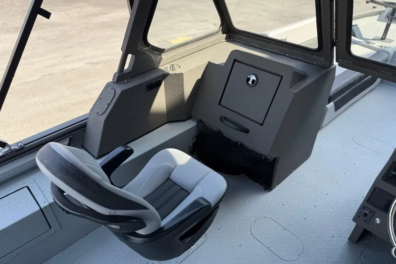 Slide: The Image of Interior of 2026 SeaArk EasyCat boat with modern seating and storage compartment. - 8