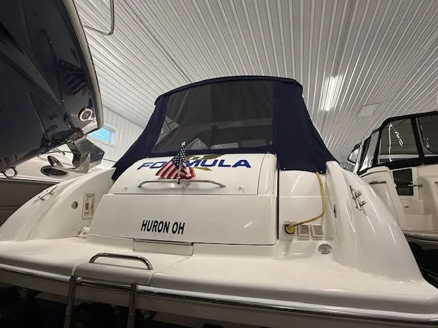 Slide: The Image of Rear view of a 2001 Formula 370 Super Sport boat in storage facility. - 4