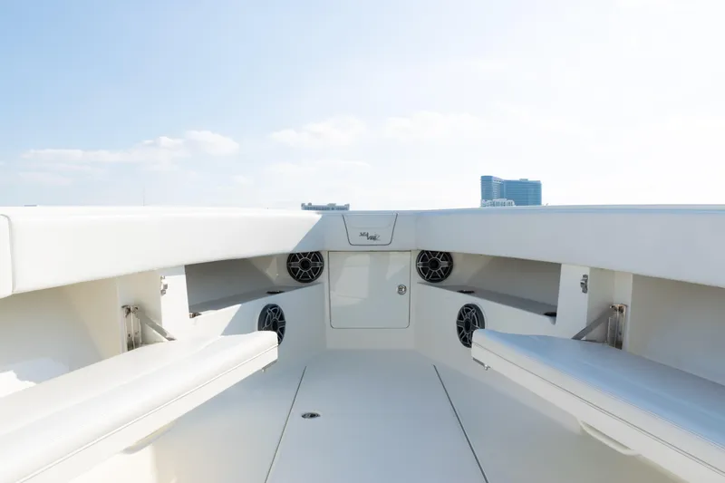 Slide: The Image of 2020 SeaVee 390Z boat interior with seating and speakers, under a clear sky. - 12