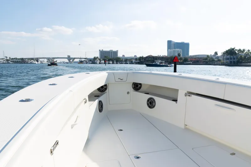 Slide: The Image of 2020 SeaVee 390Z boat interior with waterfront cityscape in the background. - 13