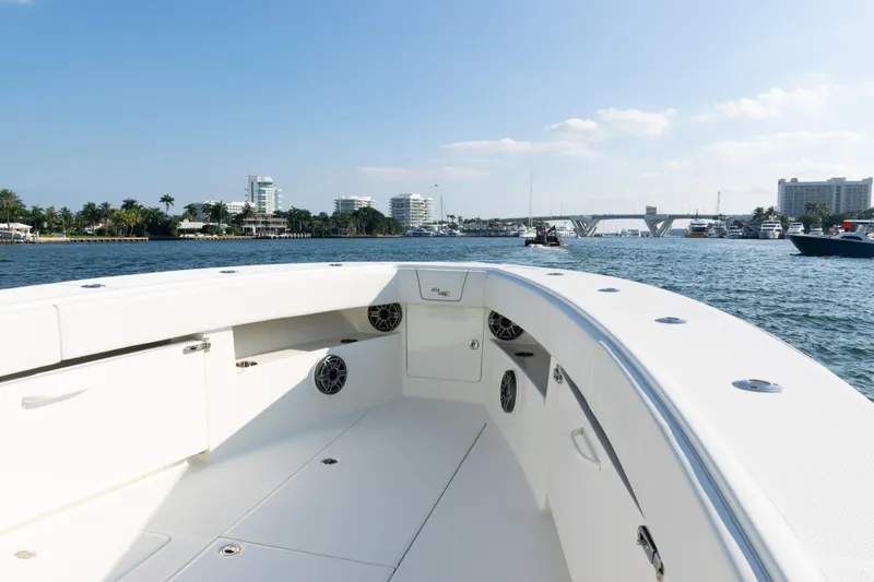 Slide: The Image of 2020 SeaVee 390Z boat cruising in a scenic waterfront setting. - 14