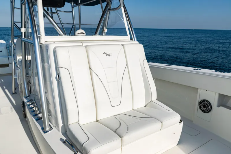 Slide: The Image of 2020 SeaVee 390Z boat with white seating, ocean backdrop, and sleek design. - 20