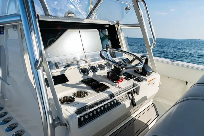 Slide: The Image of 2020 SeaVee 390Z boat dashboard with steering wheel, ocean view in background. - 23