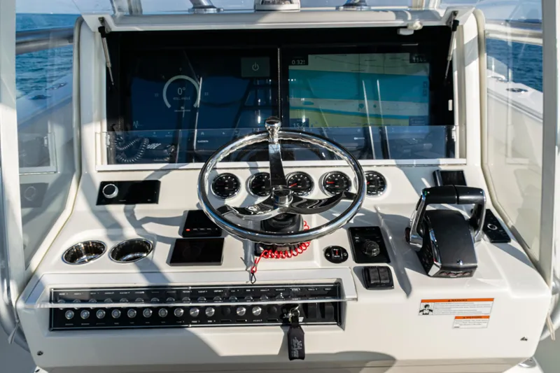 Slide: The Image of 2020 SeaVee 390Z boat dashboard with steering wheel and navigation controls. - 27