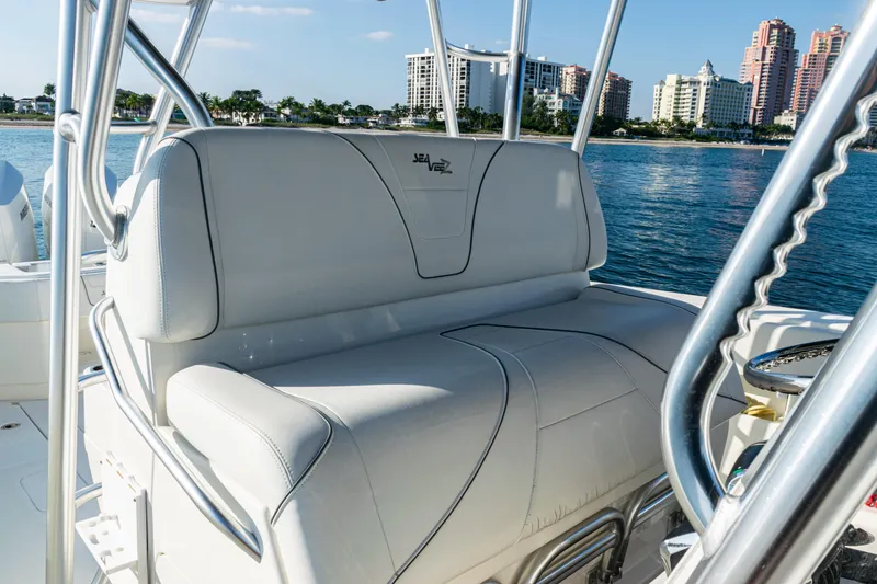 Slide: The Image of 2020 SeaVee 390Z boat interior with white seating, ocean and cityscape background. - 32