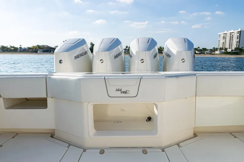 Slide: The Image of 2020 SeaVee 390Z boat with four Mercury engines, docked by the water. - 34