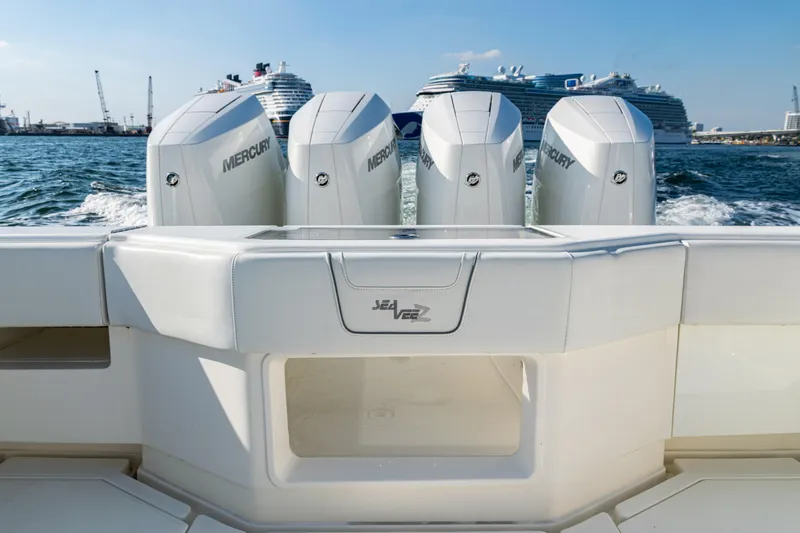 Slide: The Image of 2020 SeaVee 390Z boat with Mercury engines, cruising near large ships in a harbor. - 39