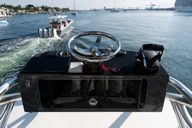 Slide: The Image of 2020 SeaVee 390Z boat helm with steering wheel and controls on open water. - 47