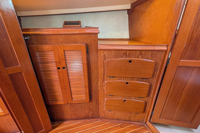 Slide: The Image of 1988 Island Packet 38 interior with wooden cabinetry and storage drawers. - 12