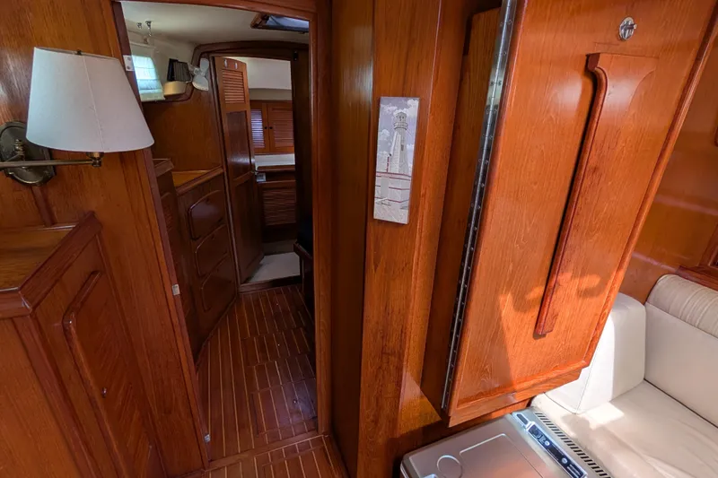 Slide: The Image of 1988 Island Packet 38 yacht interior with wooden cabinetry and cozy seating area. - 13