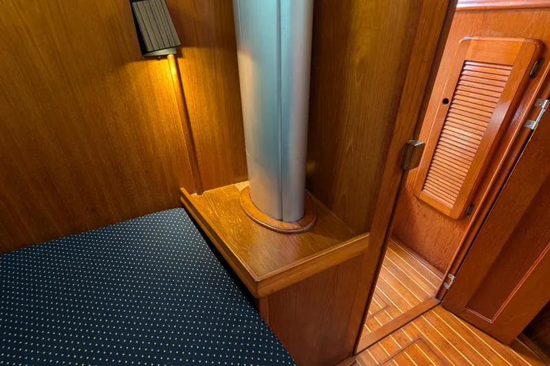 Slide: The Image of Interior of 1988 Island Packet 38 sailboat with wood paneling and cozy lighting. - 14