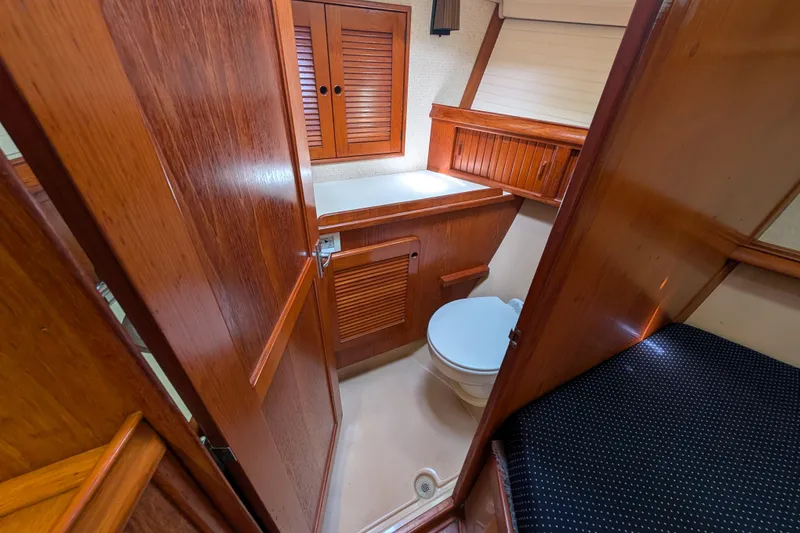 Slide: The Image of 1988 Island Packet 38 yacht bathroom with wooden cabinetry and compact design. - 15