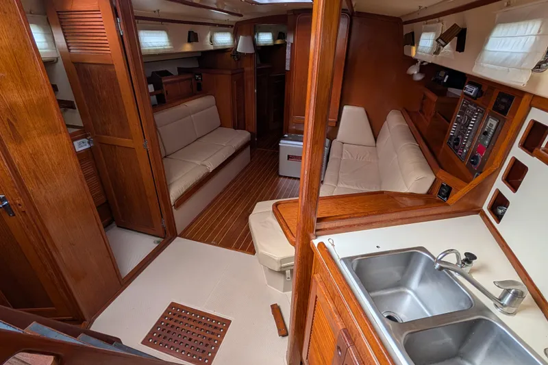Slide: The Image of Interior of 1988 Island Packet 38 sailboat with wood finish and cozy seating area. - 2