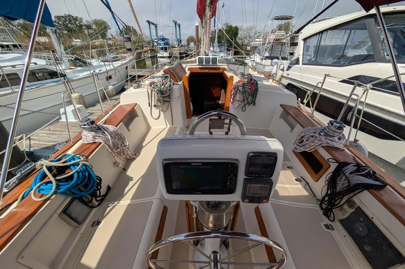 Slide: The Image of 1988 Island Packet 38 sailboat cockpit with navigation equipment and mooring lines. - 28