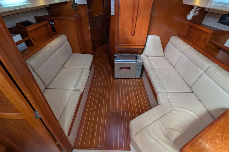 Slide: The Image of 1988 Island Packet 38 interior with beige leather seating and wooden flooring. - 3