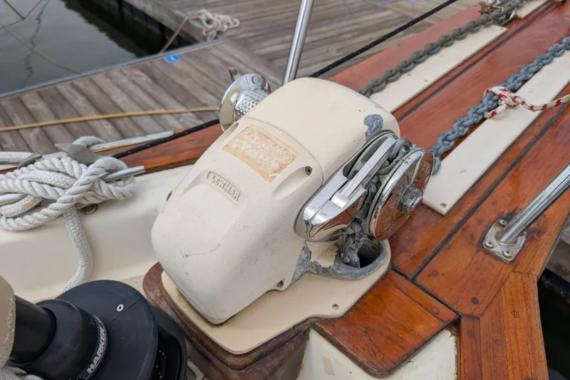 Slide: The Image of 1988 Island Packet 38 sailboat deck with anchor windlass and wooden details. - 37