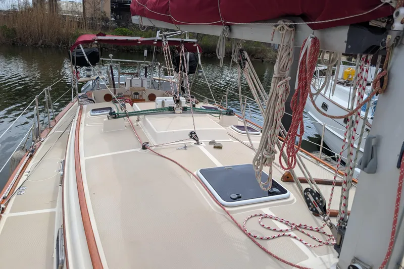 Slide: The Image of 1988 Island Packet 38 sailboat deck with rigging and maroon sail cover. - 38