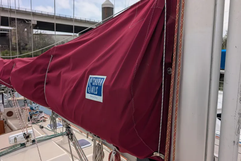 Slide: The Image of Red sail cover on 1988 Island Packet 38 sailboat, featuring Churr Sails logo. - 39