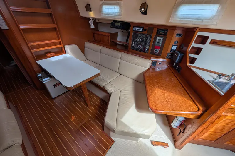 Slide: The Image of Interior of 1988 Island Packet 38 sailboat with wood finish and cozy seating area. - 4
