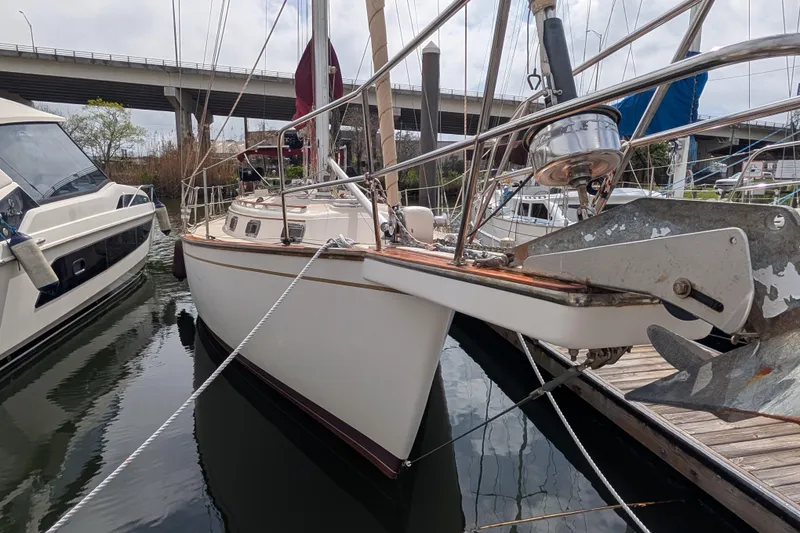 Slide: The Image of 1988 Island Packet 38 sailboat docked at marina, featuring classic design and sturdy build. - 46