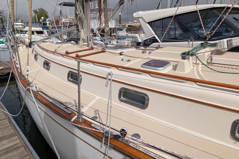 Slide: The Image of 1988 Island Packet 38 sailboat docked, showcasing deck and rigging details. - 48