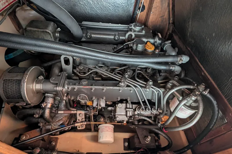 Slide: The Image of Engine of a 1988 Island Packet 38 sailboat, showcasing detailed mechanical components. - 52