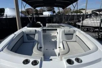 Slide: The Image of 2022 Hurricane SunDeck Sport 192 RL OB boat interior with seating and cup holders. - 6