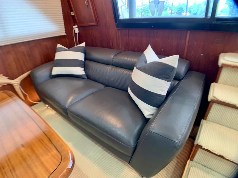 Slide: The Image of Leather sofa with striped pillows in a 1988 Harbor Master 520 Coastal. - 10