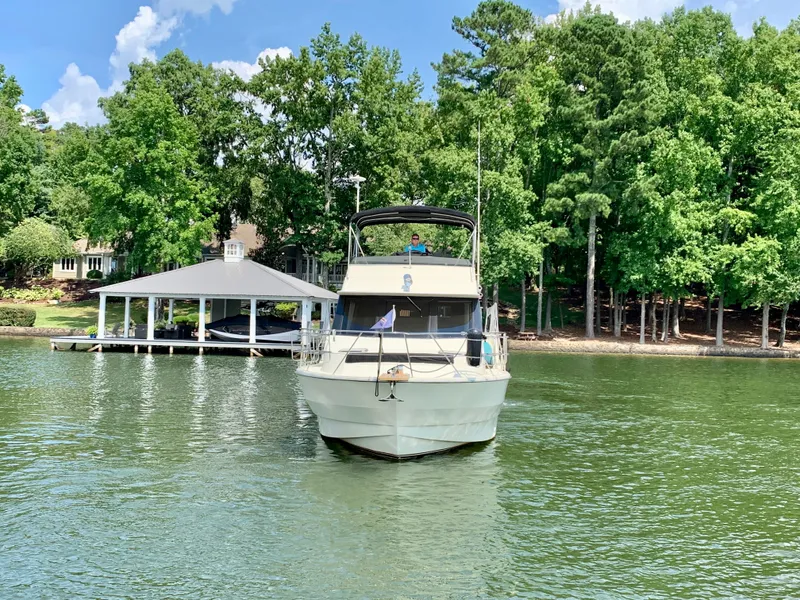 Slide: The Image of 1988 Harbor Master 520 Coastal yacht on a serene lake. - 2