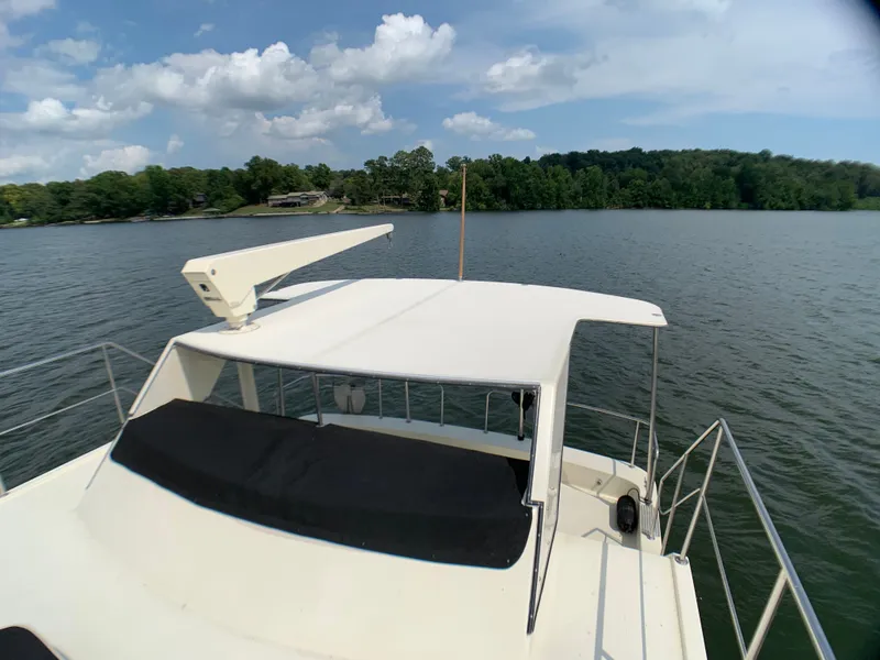 Slide: The Image of Harbor Master 520 Coastal 1988 on a serene lake with cloudy sky. - 43