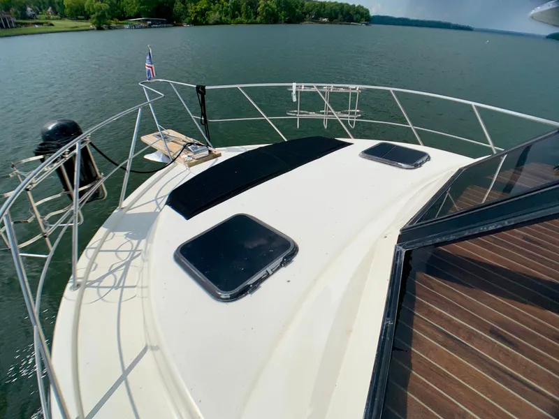 Slide: The Image of Deck of a 1988 Harbor Master 520 Coastal on a serene lake. - 47