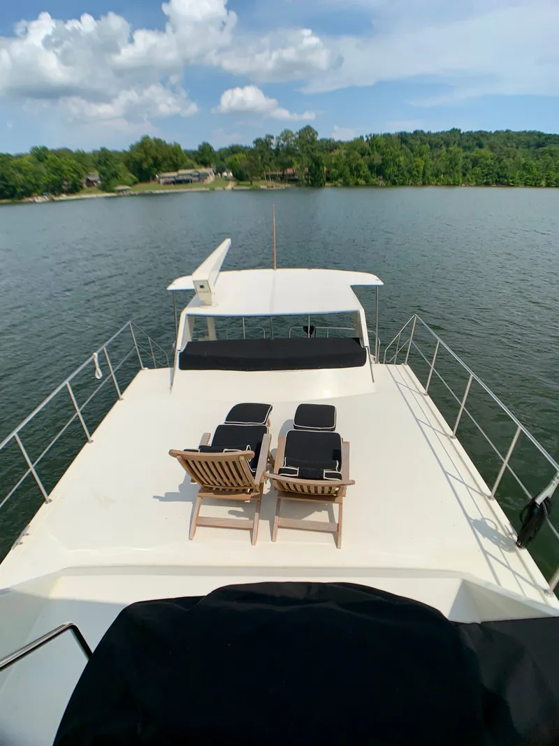 Slide: The Image of Deck of 1988 Harbor Master 520 Coastal with lounge chairs. - 49