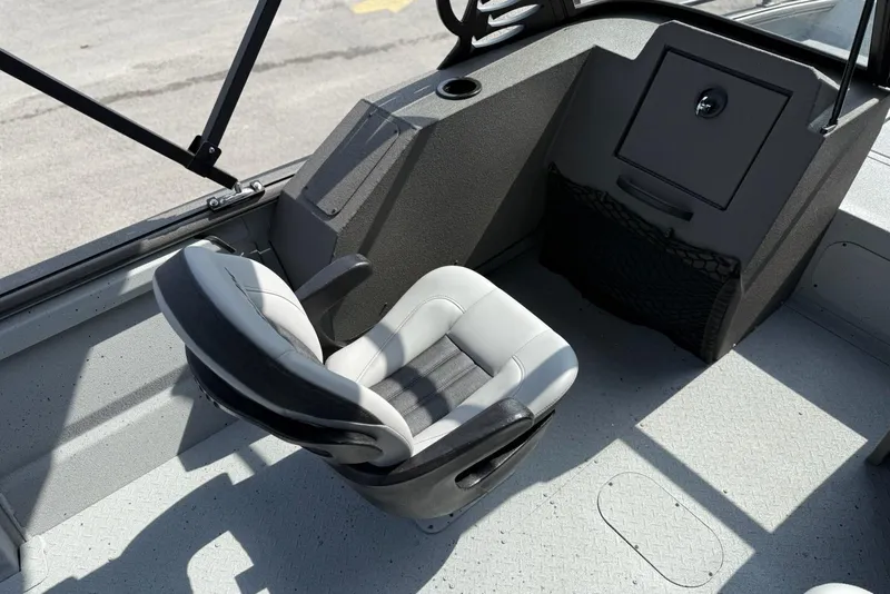 Slide: The Image of Interior of 2026 SeaArk Protege 200 boat with a swivel seat and storage compartment. - 10