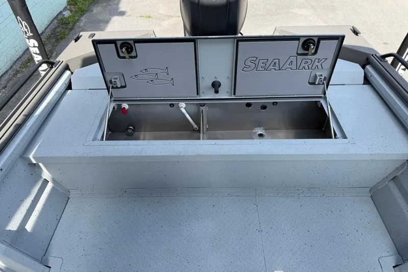 Slide: The Image of 2026 SeaArk Protege 200 boat with open storage compartment on deck. - 13