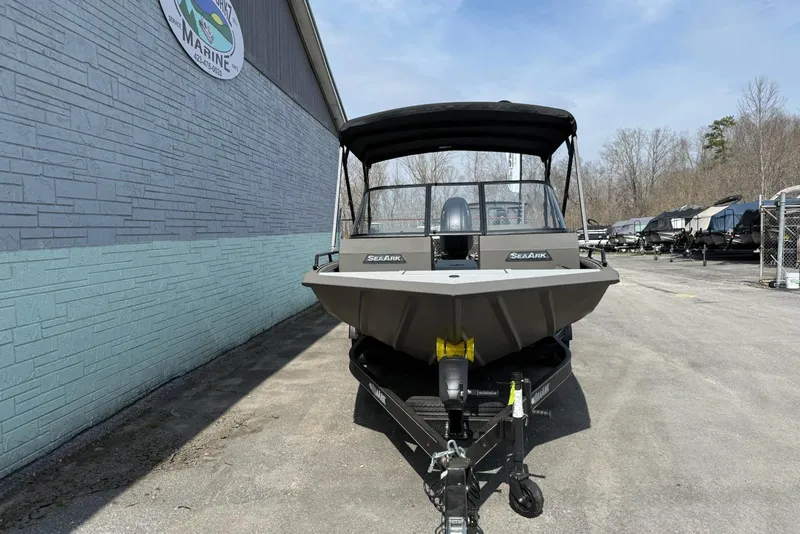 Slide: The Image of 2026 SeaArk Protege 200 boat on trailer, parked outside a marine dealership. - 4