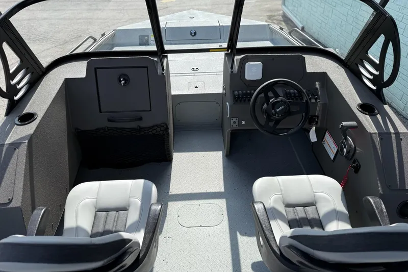 Slide: The Image of 2026 SeaArk Protege 200 boat interior with steering wheel and seating. - 9
