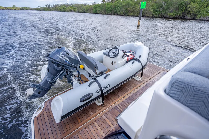 Slide: The Image of Inflatable boat with Yamaha motor on Sabre 58 Salon Express, 2025 model, cruising on water. - 13