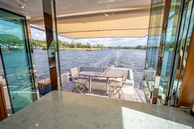 Slide: The Image of Luxurious 2025 Sabre 58 Salon Express yacht interior with scenic water view. - 16