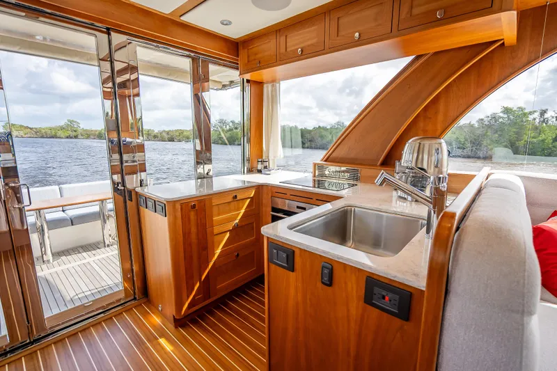 Slide: The Image of Luxurious interior of 2025 Sabre 58 Salon Express yacht with modern kitchen and scenic water view. - 20