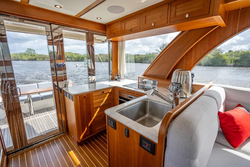 Slide: The Image of Luxurious interior of 2025 Sabre 58 Salon Express yacht with modern kitchen and scenic view. - 24