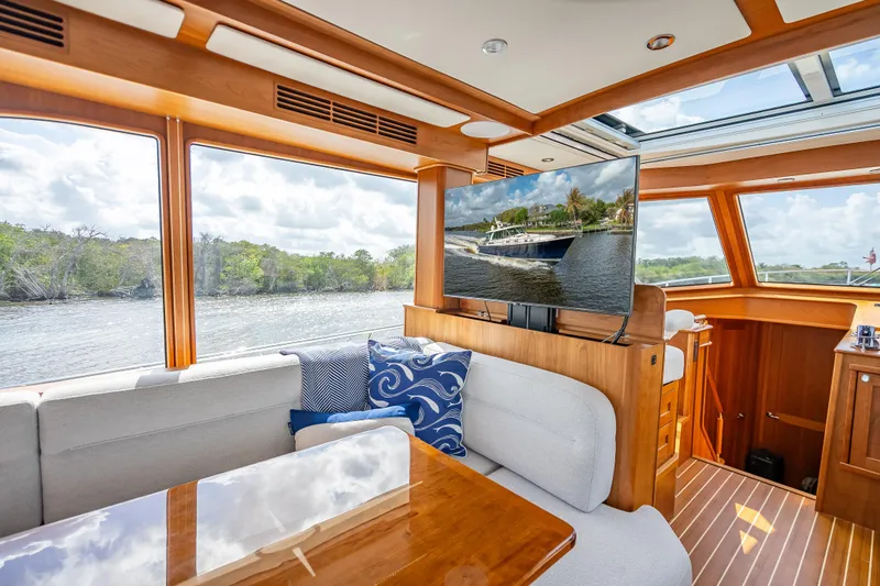 Slide: The Image of Interior of 2025 Sabre 58 Salon Express yacht with scenic waterway view. - 30