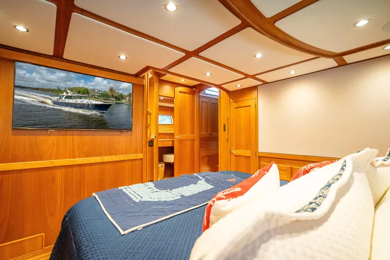 Slide: The Image of Luxurious interior of 2025 Sabre 58 Salon Express yacht with wood paneling and cozy bedding. - 41