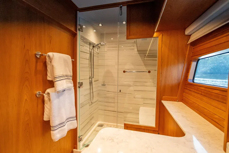 Slide: The Image of Luxurious bathroom in 2025 Sabre 58 Salon Express yacht with glass shower and wooden accents. - 44