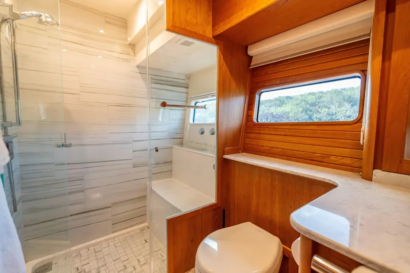 Slide: The Image of Luxurious bathroom interior of 2025 Sabre 58 Salon Express yacht with modern shower and wooden accents. - 45